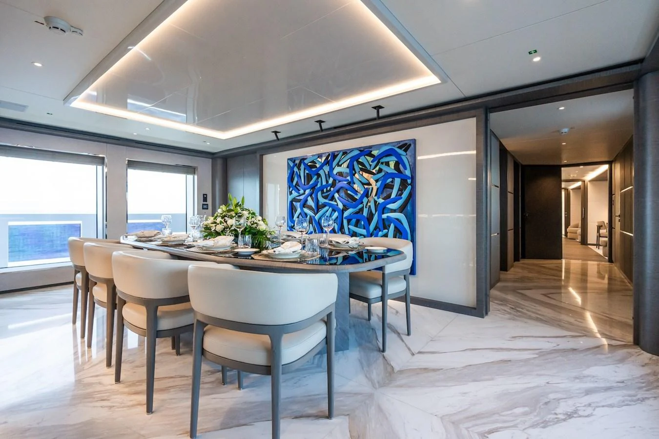 a large room with a table and chairs aboard FORTUNA Yacht for Sale