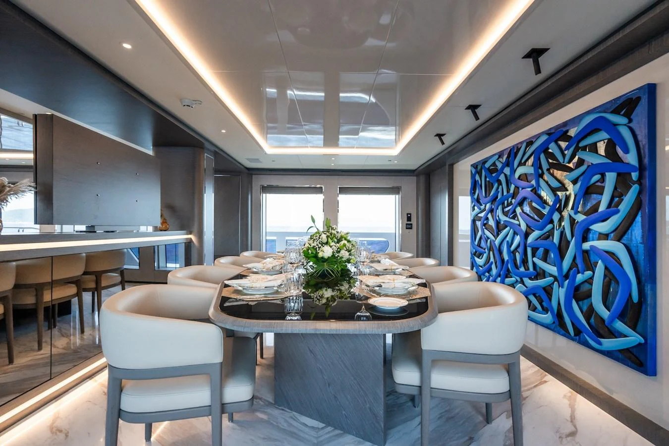 a room with a table and chairs aboard FORTUNA Yacht for Sale