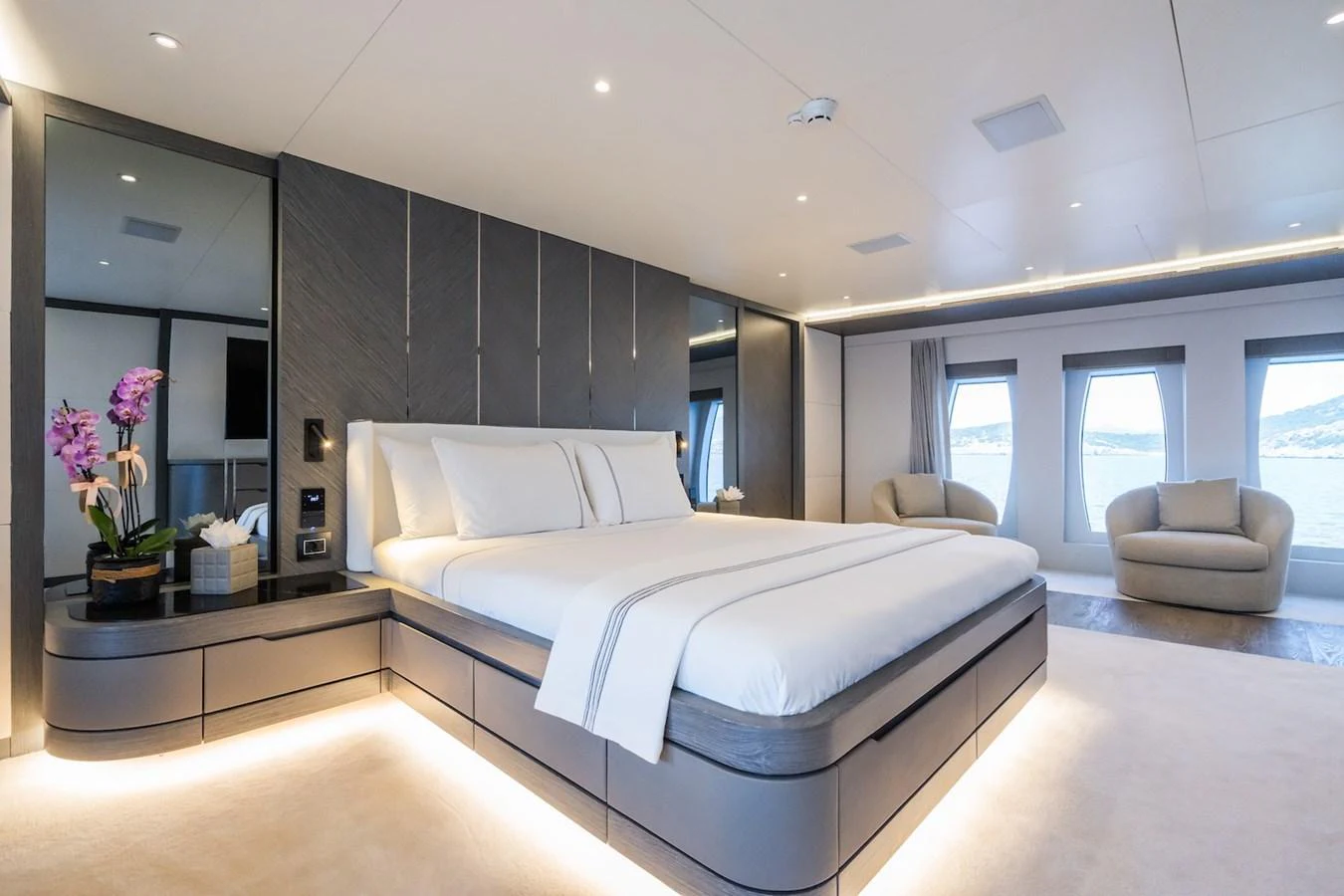a modern bedroom with a large bed aboard FORTUNA Yacht for Sale
