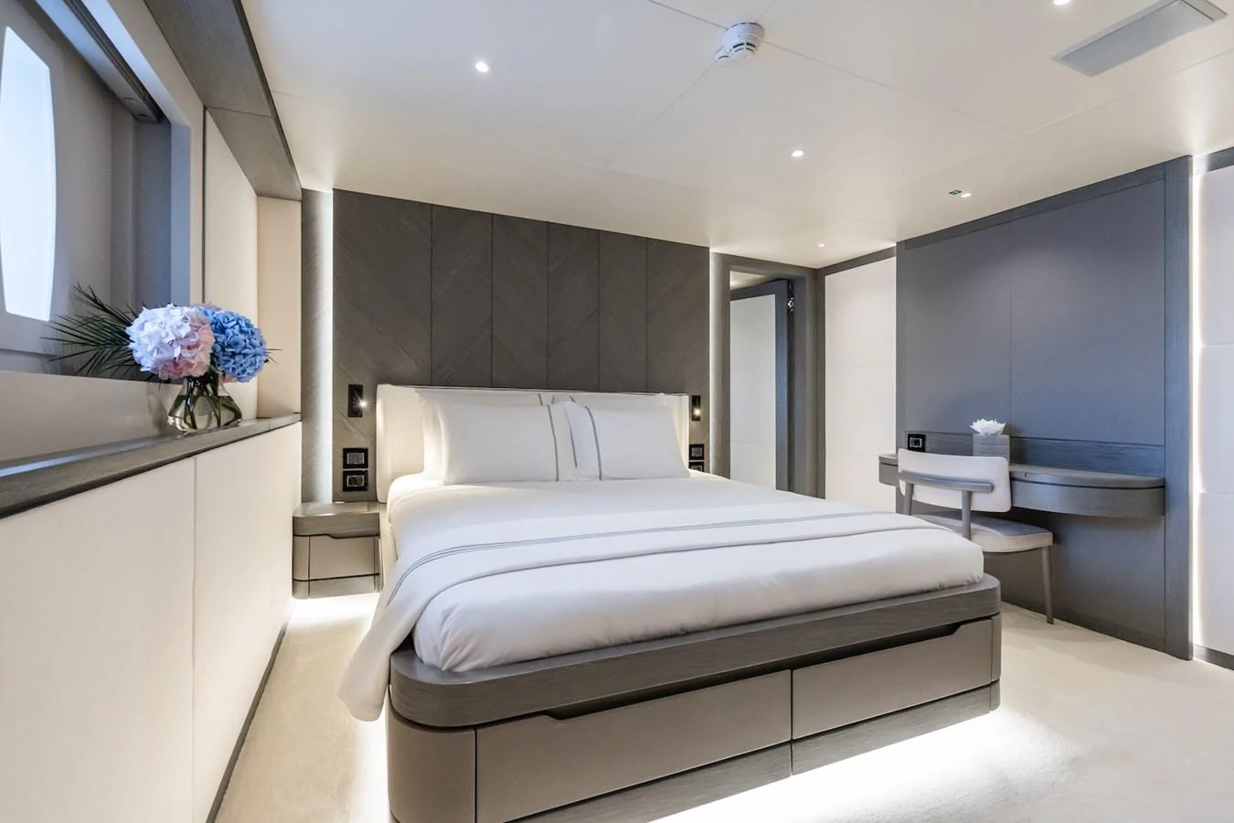a bedroom with a bed and a desk aboard FORTUNA Yacht for Sale