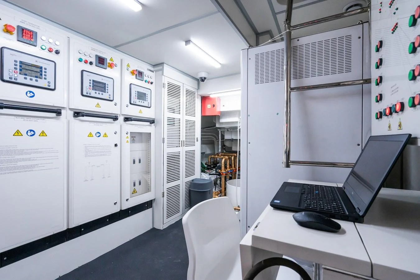 a laptop on a desk in a lab aboard FORTUNA Yacht for Sale