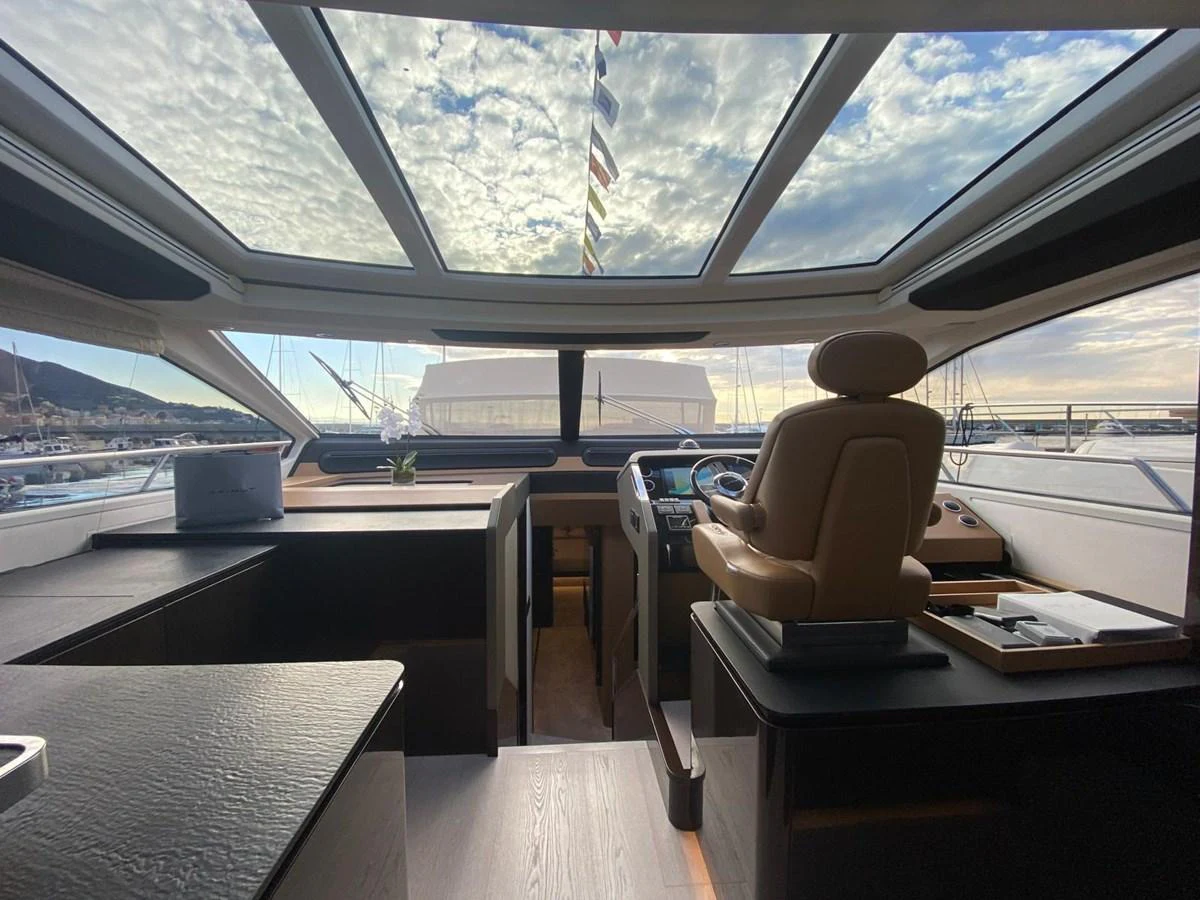 a room with a chair and a table and a flag aboard 10009846 Yacht for Sale