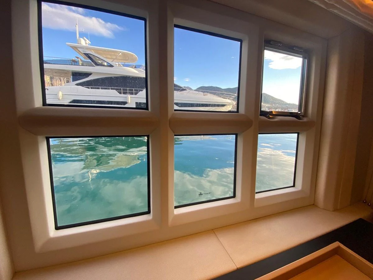 a window with a plane in the background aboard 10009846 Yacht for Sale