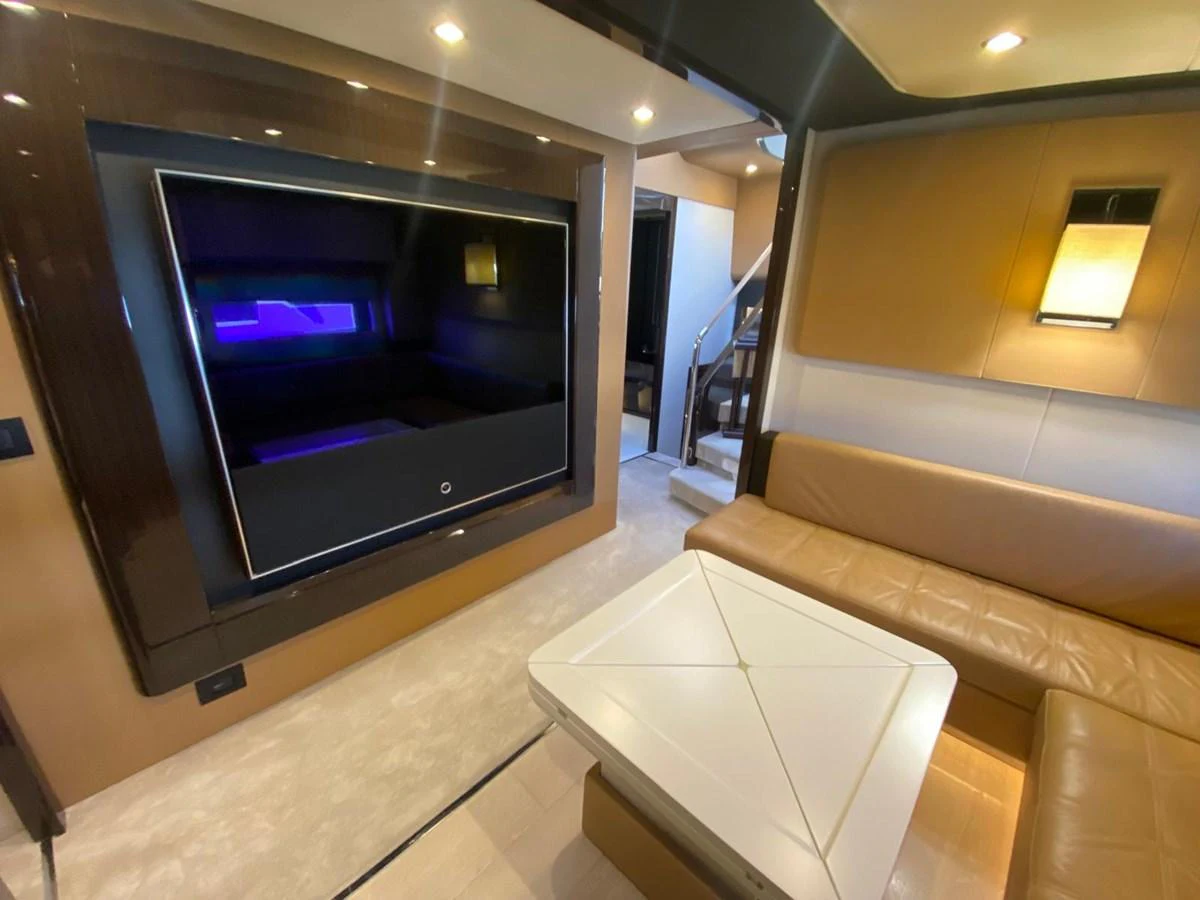 a living room with a tv aboard 10009846 Yacht for Sale