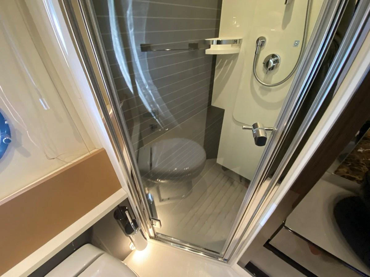 a bathroom with a glass shower aboard 10009846 Yacht for Sale