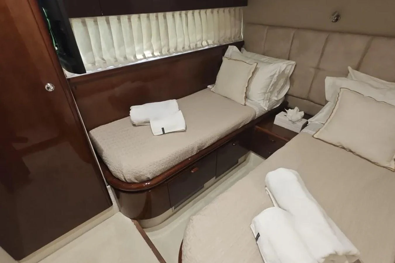 a bed with white pillows aboard HINXXLVI02 Yacht for Sale