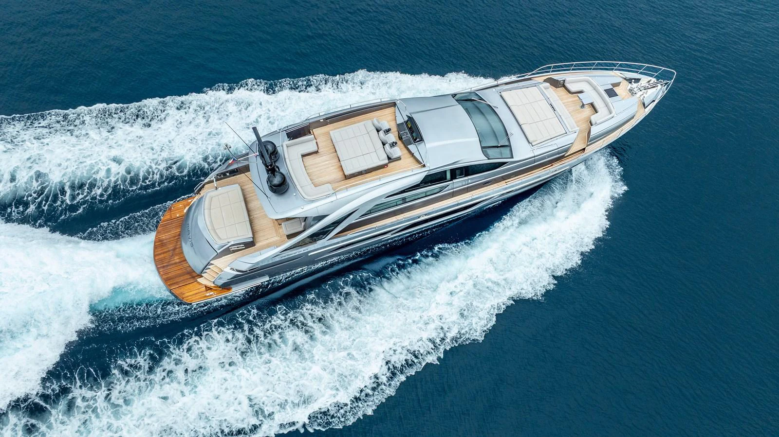 A sleek and modern yacht cruises through the open water, showcasing its elegant design and spacious deck areas. aboard MAVIS Yacht for Sale