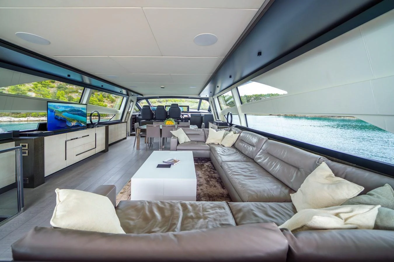 The luxurious salon features a spacious seating area with panoramic windows offering stunning views. aboard MAVIS Yacht for Sale