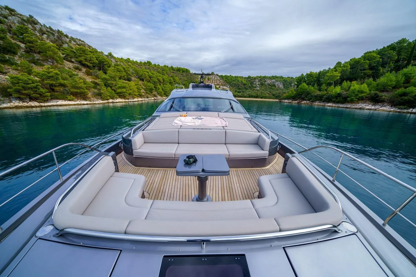 The yacht's foredeck features spacious seating with a table, perfect for enjoying scenic views. aboard MAVIS Yacht for Sale