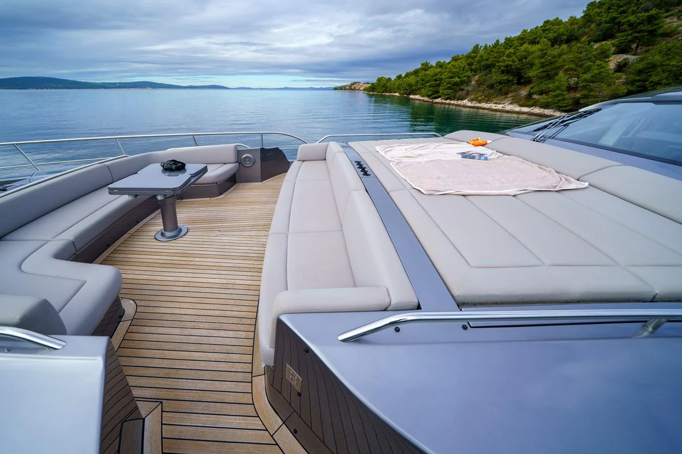 The foredeck offers a spacious sunbathing area with plush cushions and a small table, perfect for relaxation. aboard MAVIS Yacht for Sale