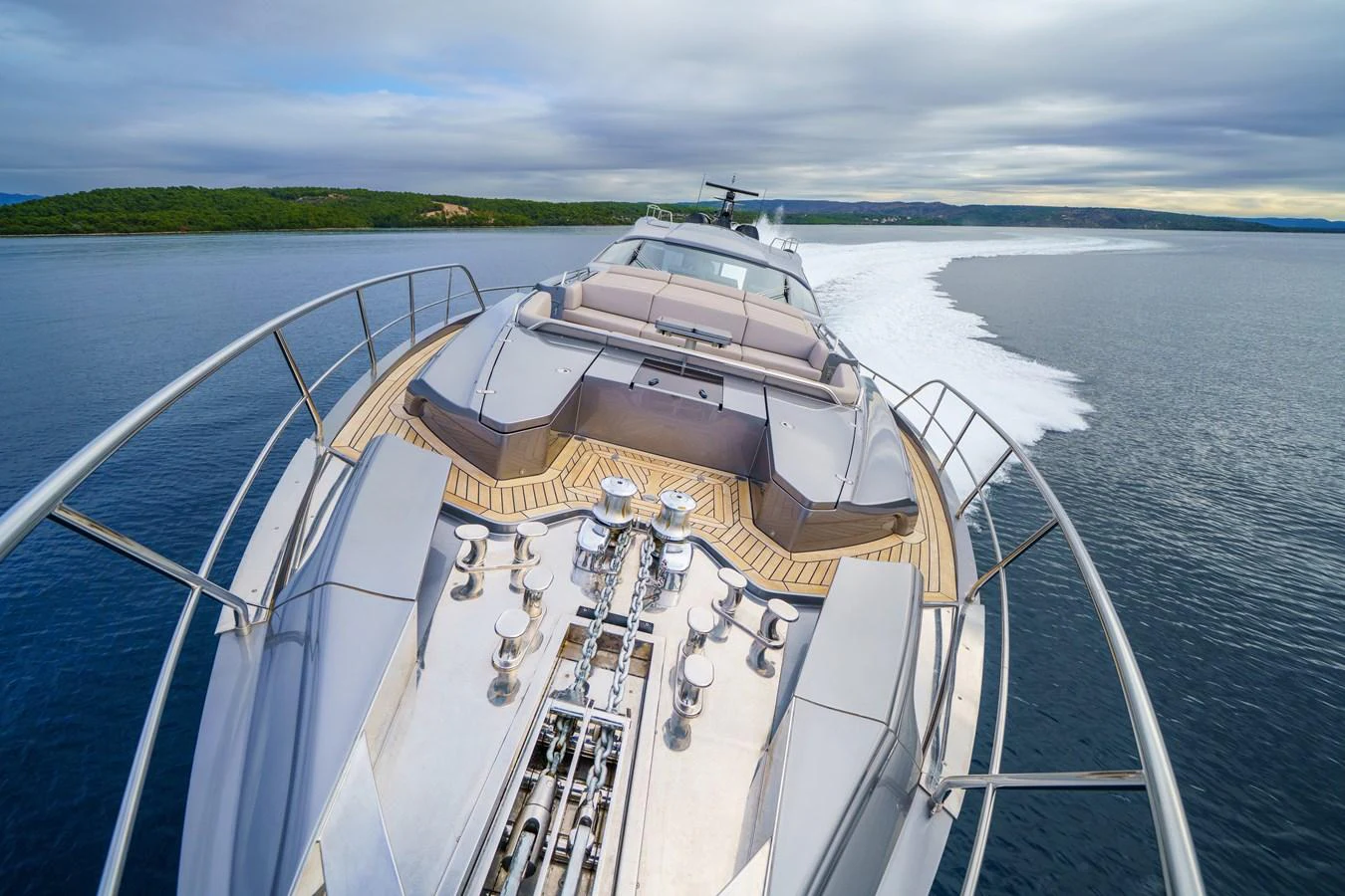 The yacht's bow showcases sleek design and luxurious sunbathing areas while cruising through serene waters. aboard MAVIS Yacht for Sale