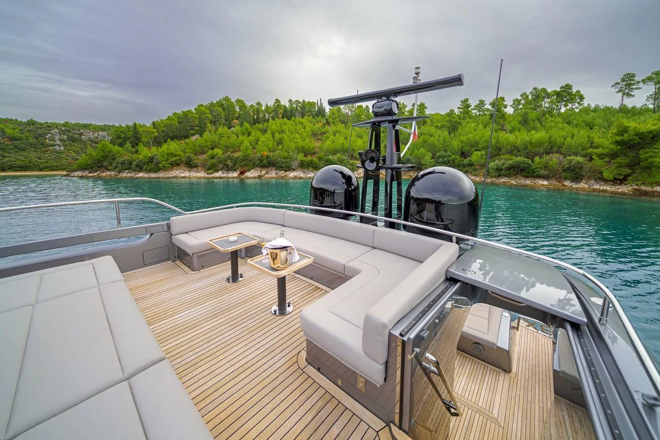 The flybridge offers a spacious seating area with a beautiful view of the surrounding waters and lush greenery. aboard MAVIS Yacht for Sale
