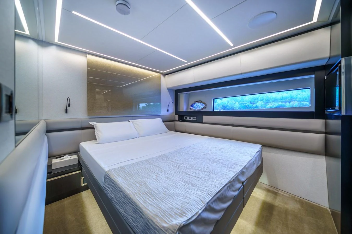 A modern stateroom with sleek design and a large window offering scenic views. aboard MAVIS Yacht for Sale