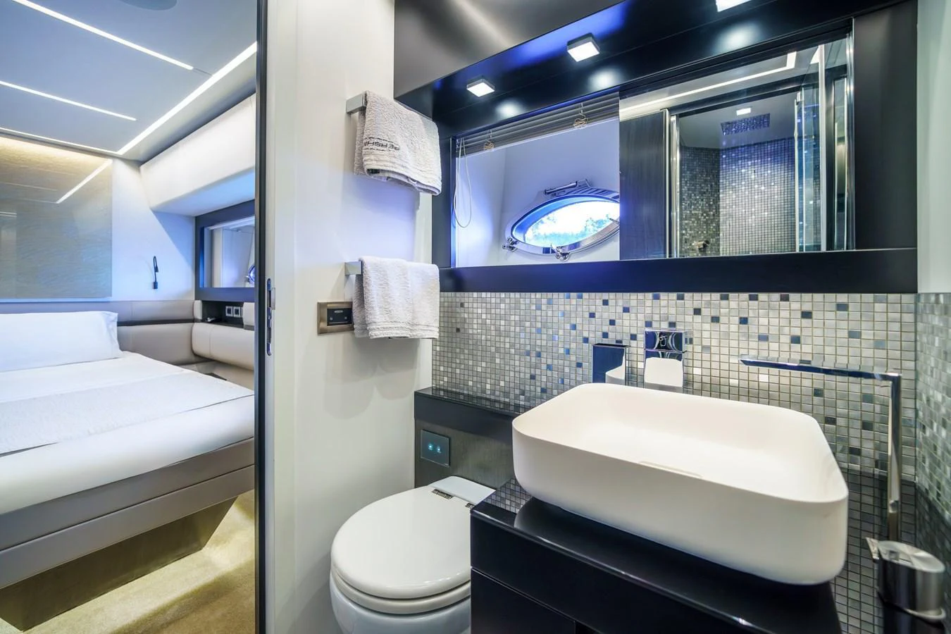 This image showcases a modern yacht bathroom with a sleek design and adjacent bedroom. aboard MAVIS Yacht for Sale