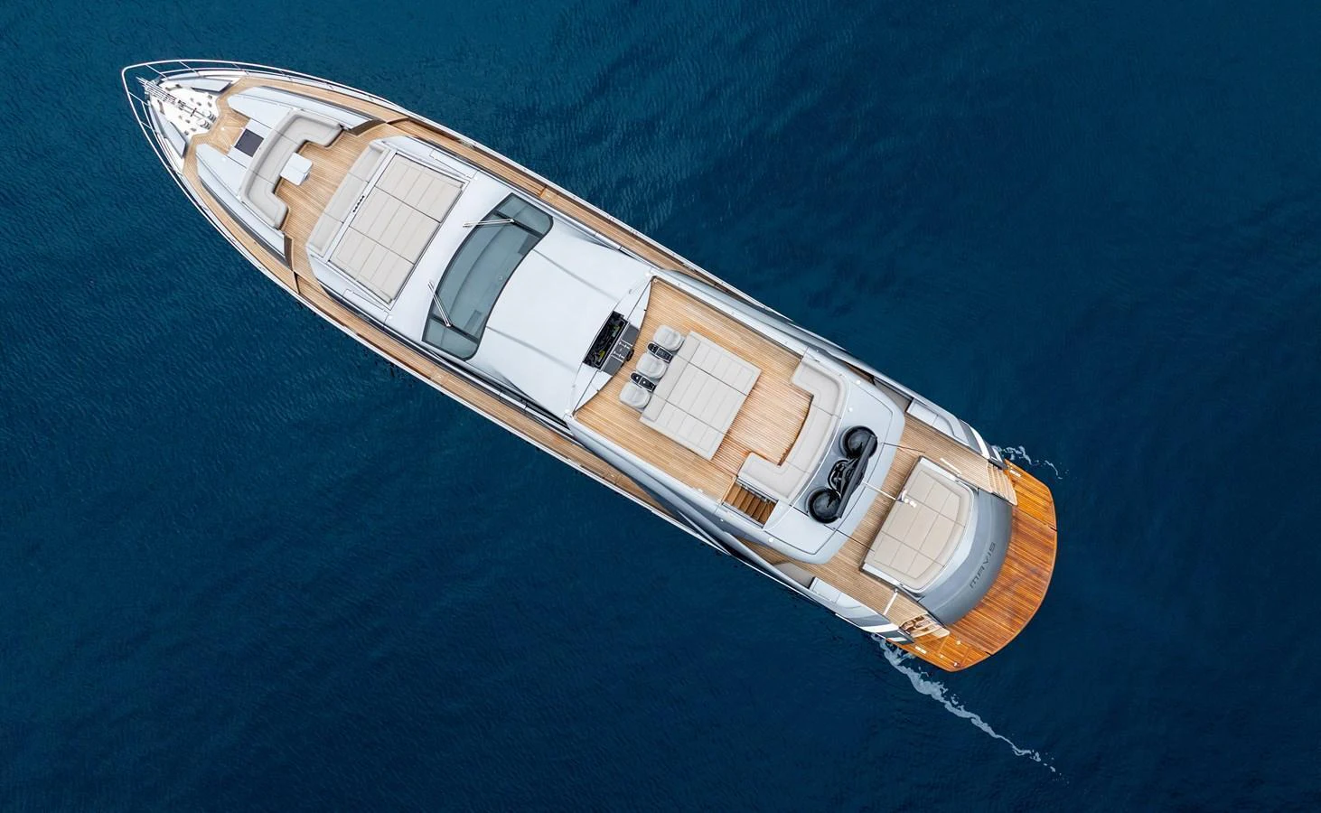 A stunning aerial view of a sleek yacht cruising through deep blue waters. aboard MAVIS Yacht for Sale
