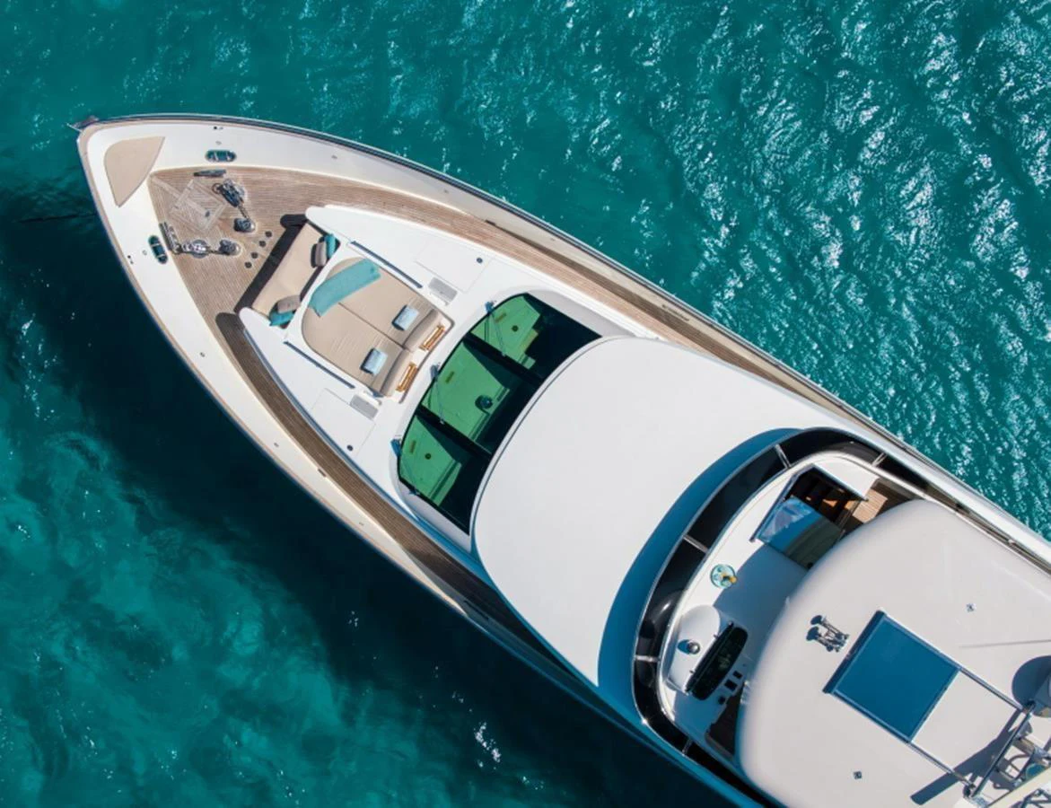 A stunning aerial view of a sleek yacht cruising through clear turquoise waters. aboard MR & MRS SMITH Yacht for Sale