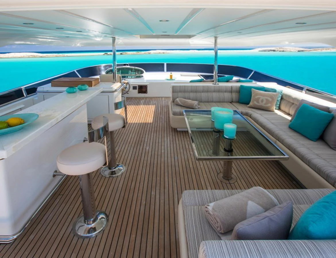 The flybridge offers a spacious and inviting area with comfortable seating and stunning ocean views. aboard MR & MRS SMITH Yacht for Sale