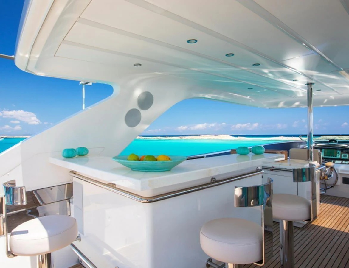 The flybridge features a sleek bar area with stunning ocean views. aboard MR & MRS SMITH Yacht for Sale