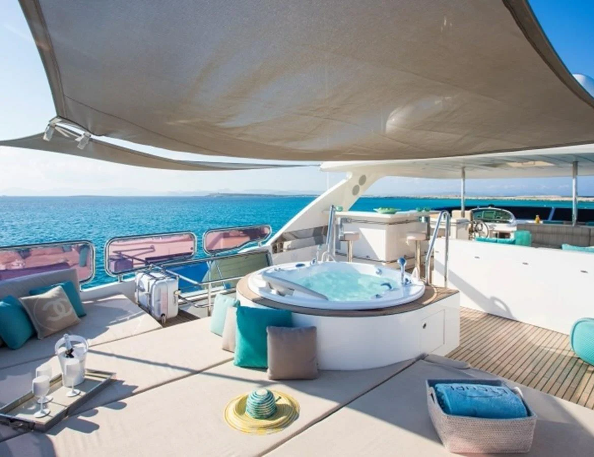 The sundeck features a luxurious jacuzzi surrounded by comfortable lounging areas with stunning ocean views. aboard MR & MRS SMITH Yacht for Sale