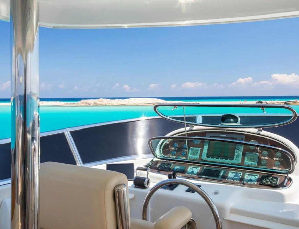 The helm station offers a stunning panoramic view of the turquoise waters and distant islands. aboard MR & MRS SMITH Yacht for Sale