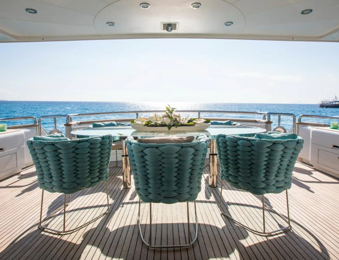 The aft deck features a stylish dining area with a stunning ocean view. aboard MR & MRS SMITH Yacht for Sale