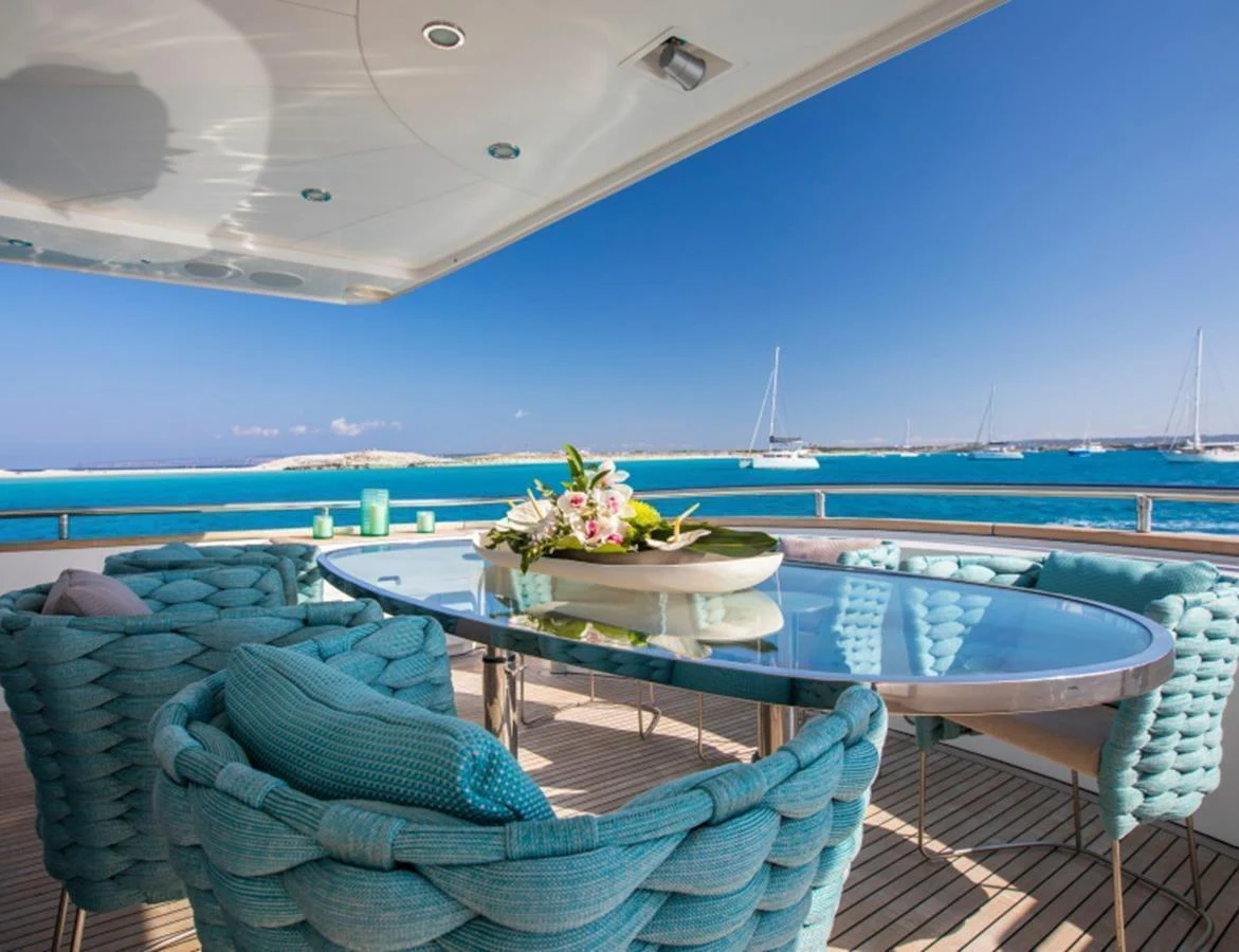 The aft deck offers a stunning al fresco dining area with a view of the serene blue waters. aboard MR & MRS SMITH Yacht for Sale