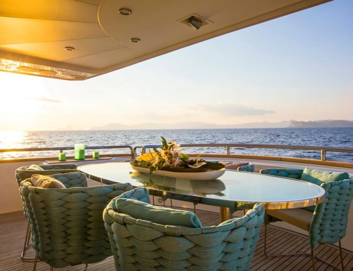 The aft deck features a stylish dining area with a stunning ocean view. aboard MR & MRS SMITH Yacht for Sale