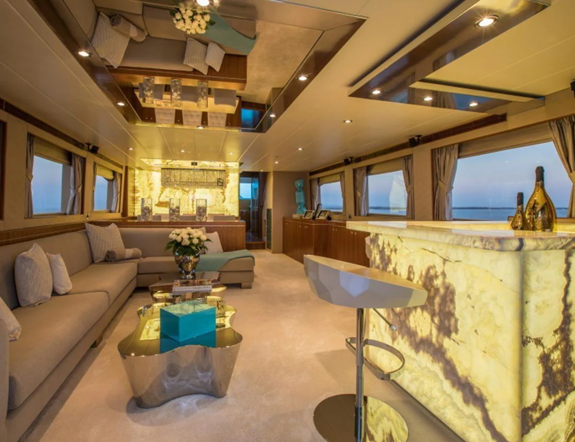 The luxurious salon features elegant seating, a stylish bar, and panoramic windows offering stunning views. aboard MR & MRS SMITH Yacht for Sale