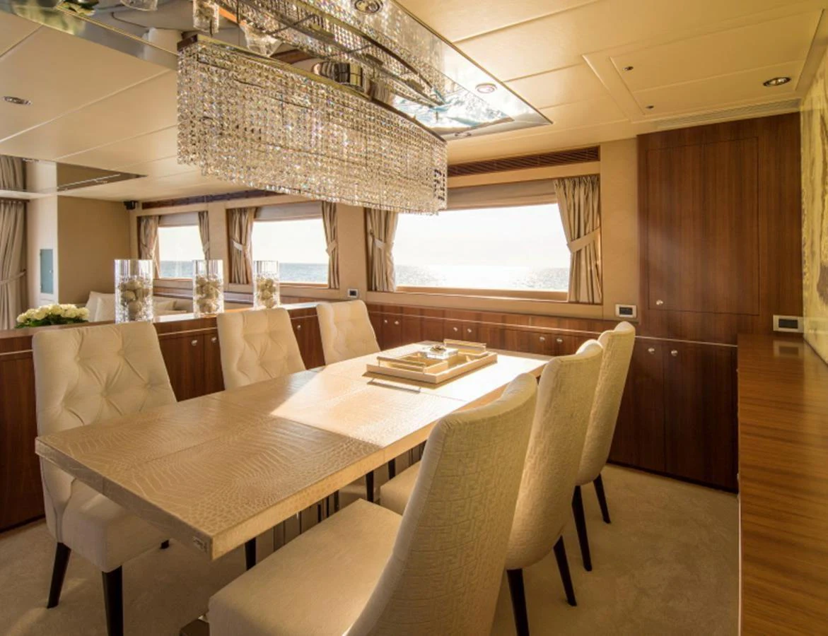 The yacht's dining area features a luxurious table with plush seating and elegant lighting. aboard MR & MRS SMITH Yacht for Sale