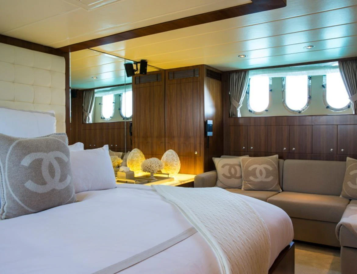 The master stateroom features luxurious bedding, elegant wood paneling, and ample natural light from the portholes. aboard MR & MRS SMITH Yacht for Sale