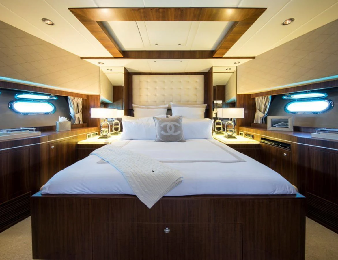 The master stateroom features a luxurious bed with elegant wood paneling and ambient lighting. aboard MR & MRS SMITH Yacht for Sale