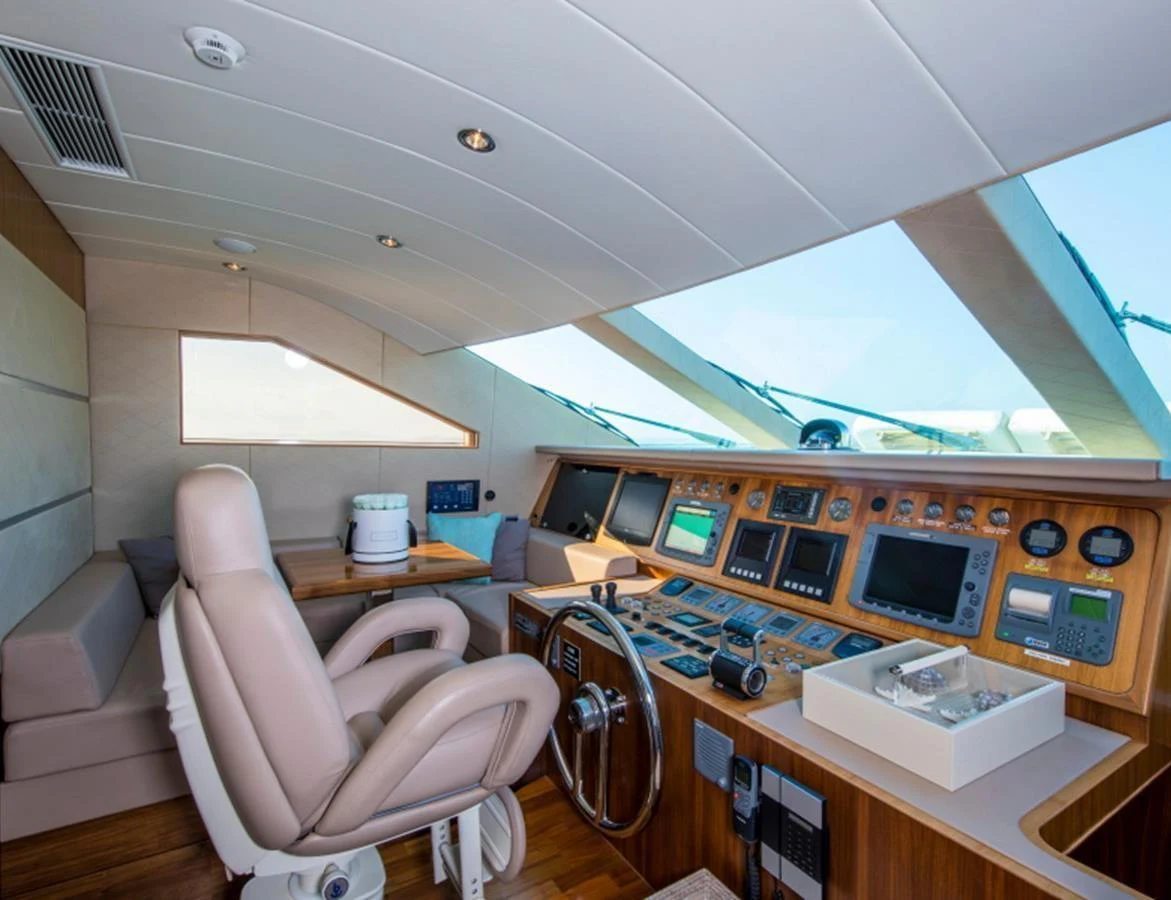 The helm station features advanced navigation equipment and a comfortable captain's chair. aboard MR & MRS SMITH Yacht for Sale