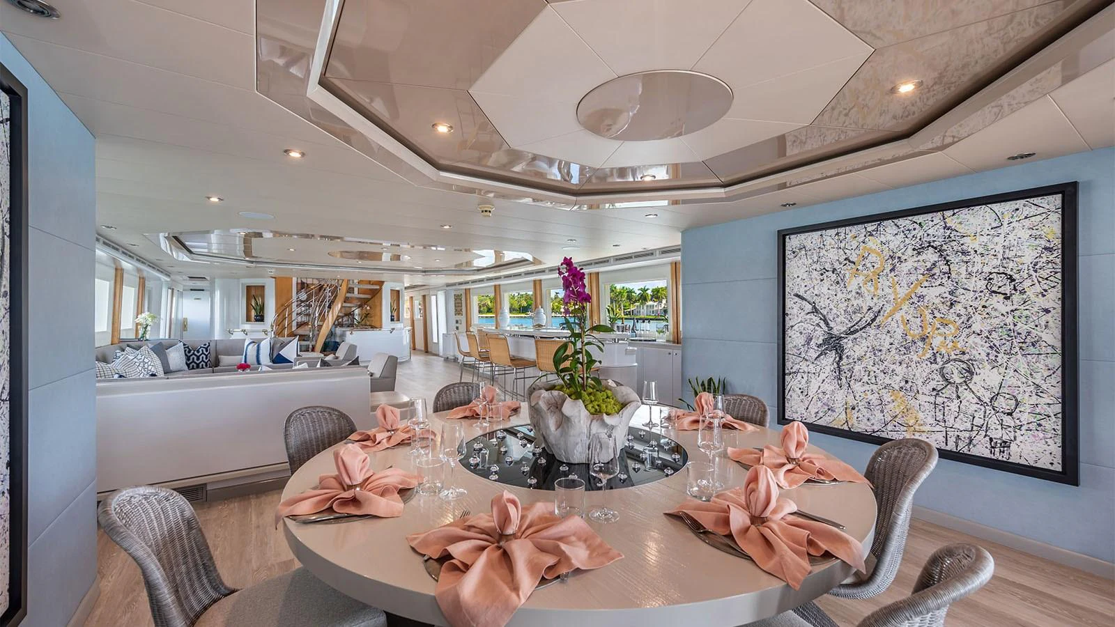 a dining room with a large painting aboard SURINA Yacht for Sale