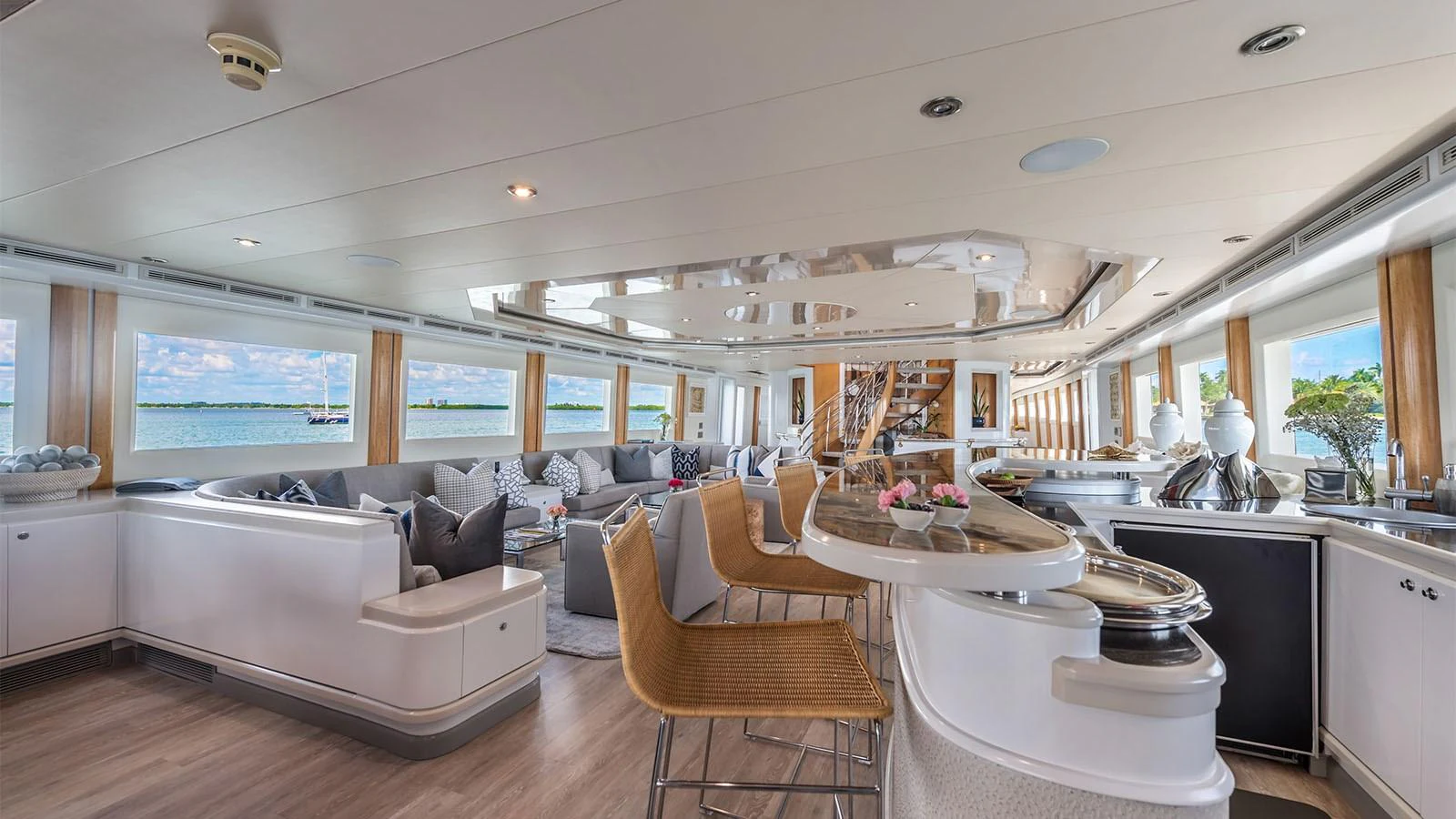 a large living room with a large white table and chairs aboard SURINA Yacht for Sale