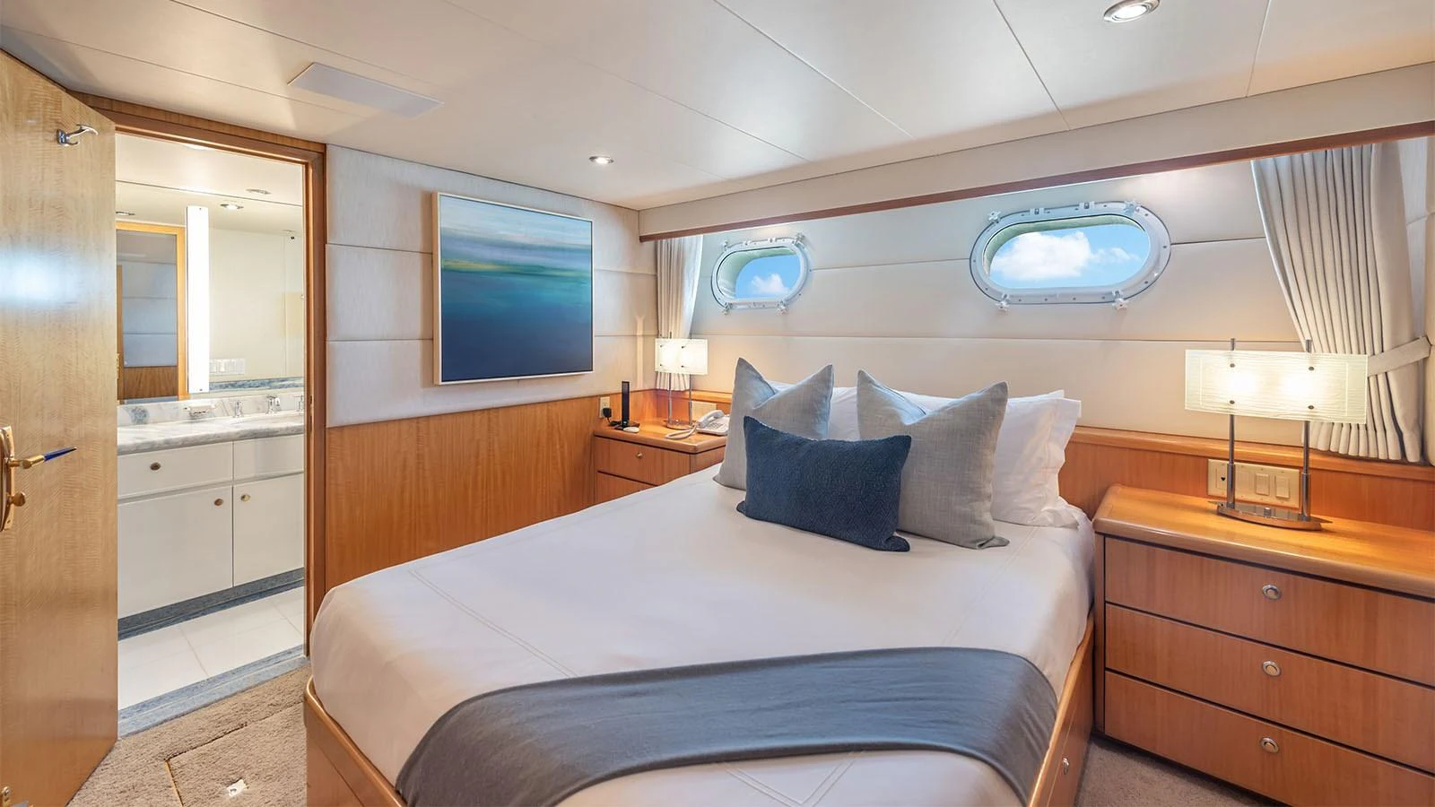 a bedroom with a bed and a tv on the wall aboard SURINA Yacht for Sale