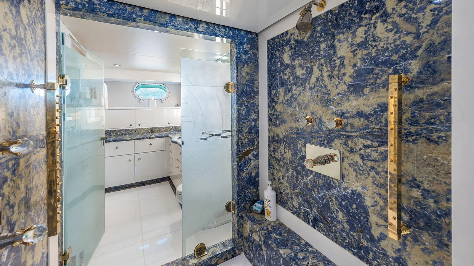 a bathroom with blue walls aboard SURINA Yacht for Sale