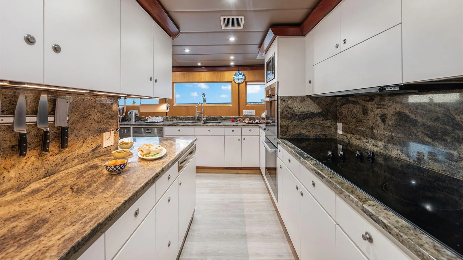 a kitchen with white cabinets aboard SURINA Yacht for Sale