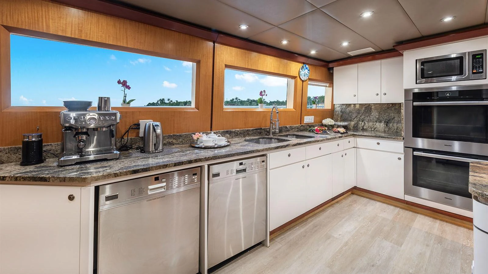 a kitchen with white cabinets aboard SURINA Yacht for Sale