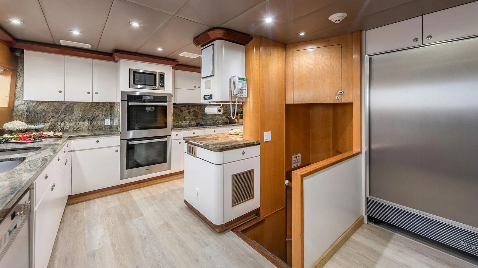 a kitchen with wooden cabinets aboard SURINA Yacht for Sale