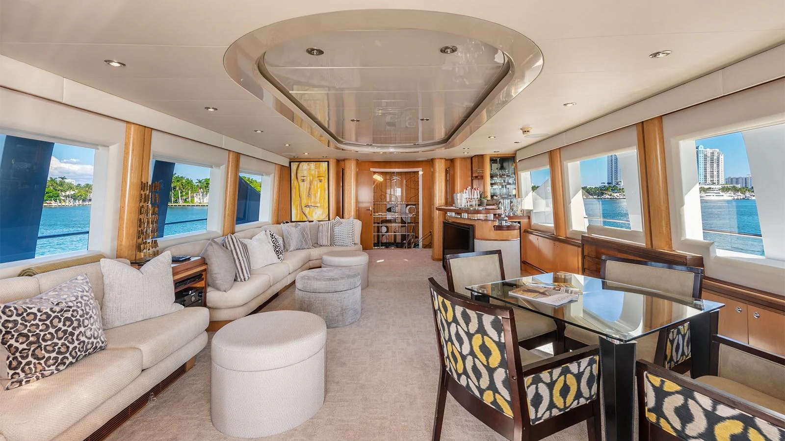 a living room with a large glass table and chairs aboard SURINA Yacht for Sale