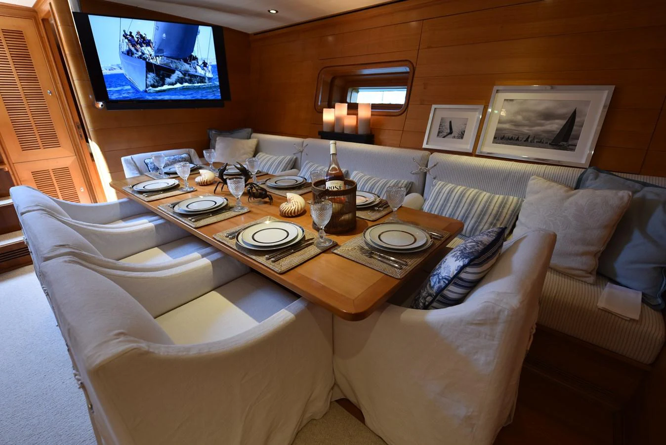 a table with plates and glasses on it aboard GREEN EYES Yacht for Sale