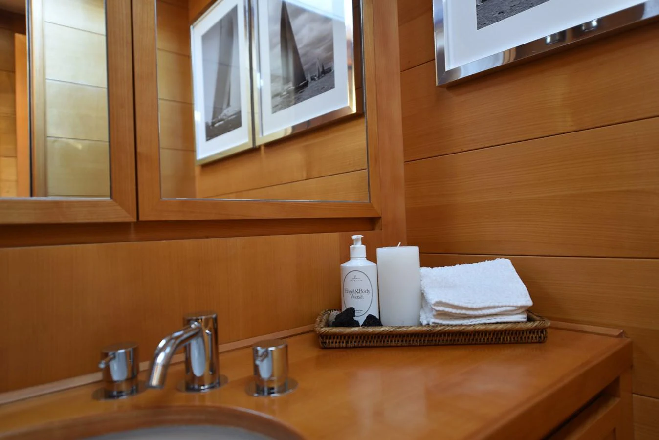a bathroom sink with a mirror and towels on it aboard GREEN EYES Yacht for Sale