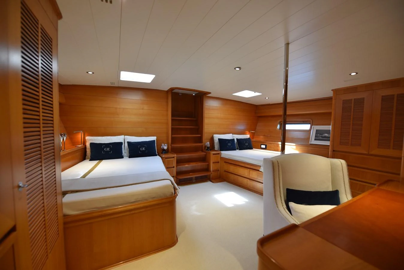 a room with a bed and a chair aboard GREEN EYES Yacht for Sale