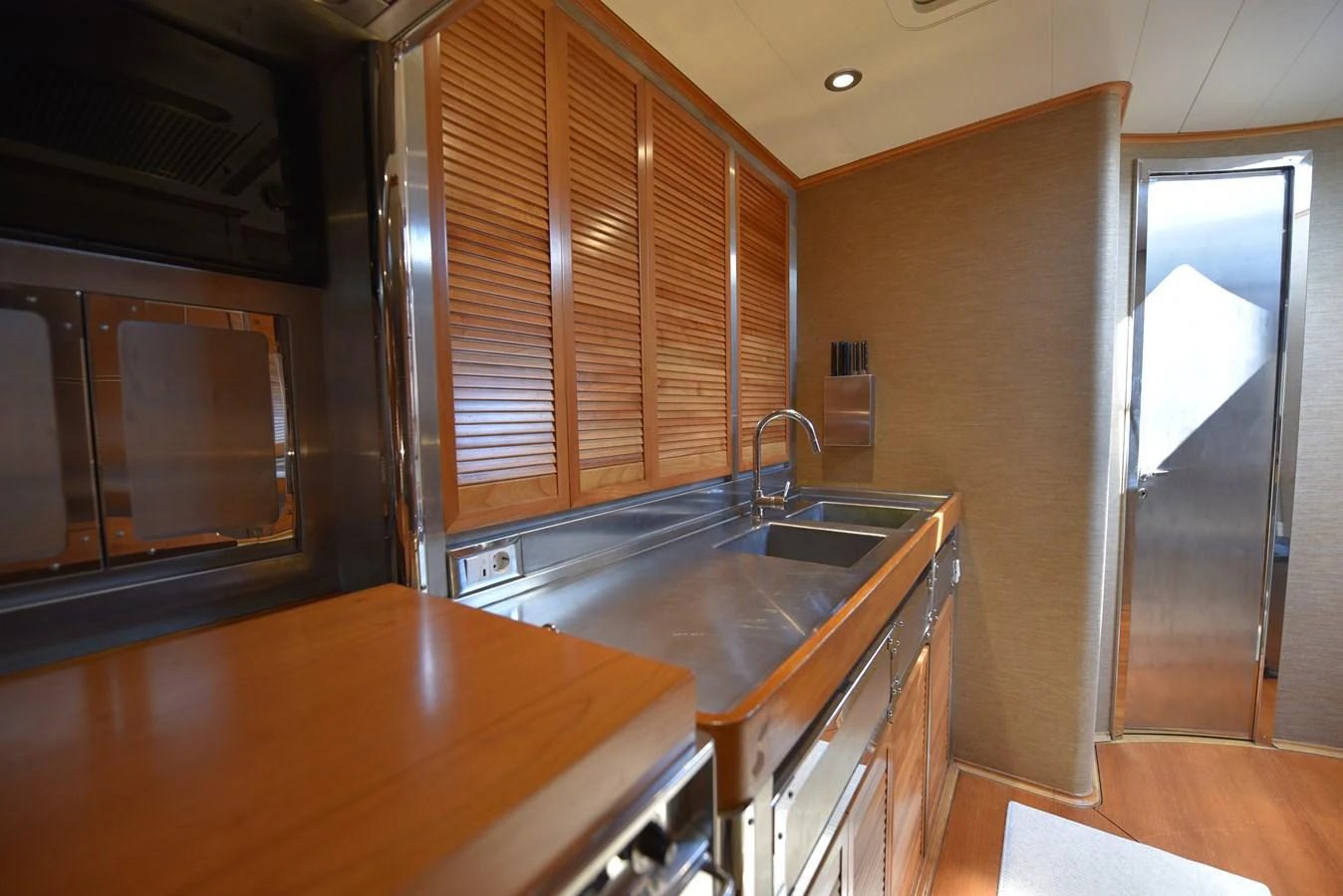 a kitchen with wooden cabinets aboard GREEN EYES Yacht for Sale