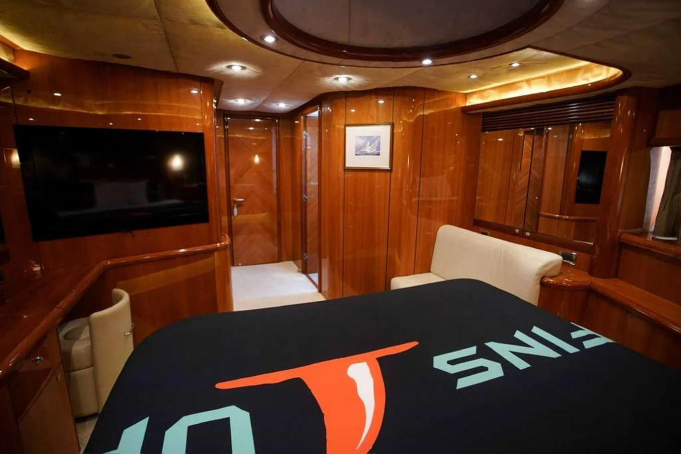 The stateroom features luxurious wood paneling and modern amenities for a comfortable stay. aboard 2006 SUNSEEKER MANHATTAN 'FINS UP' Yacht for Sale