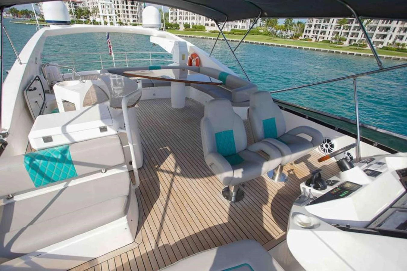 The flybridge offers a spacious and inviting area for relaxation and navigation with stunning views of the surrounding waters. aboard 2006 SUNSEEKER MANHATTAN 'FINS UP' Yacht for Sale