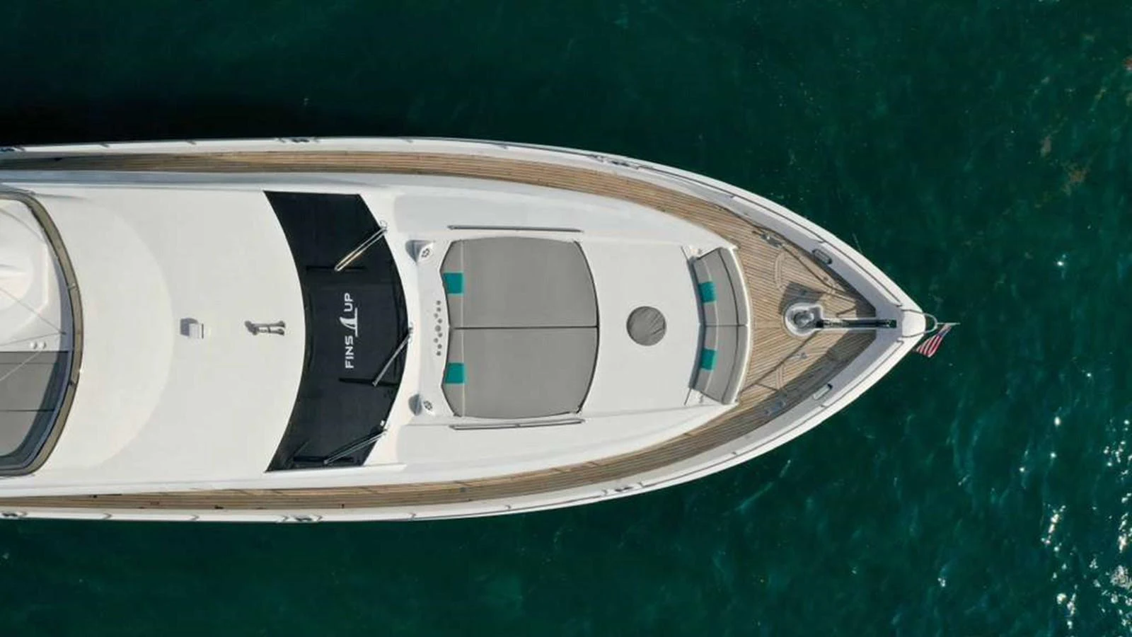 The foredeck of the yacht features spacious sun pads and a sleek design, perfect for relaxation. aboard 2006 SUNSEEKER MANHATTAN 'FINS UP' Yacht for Sale