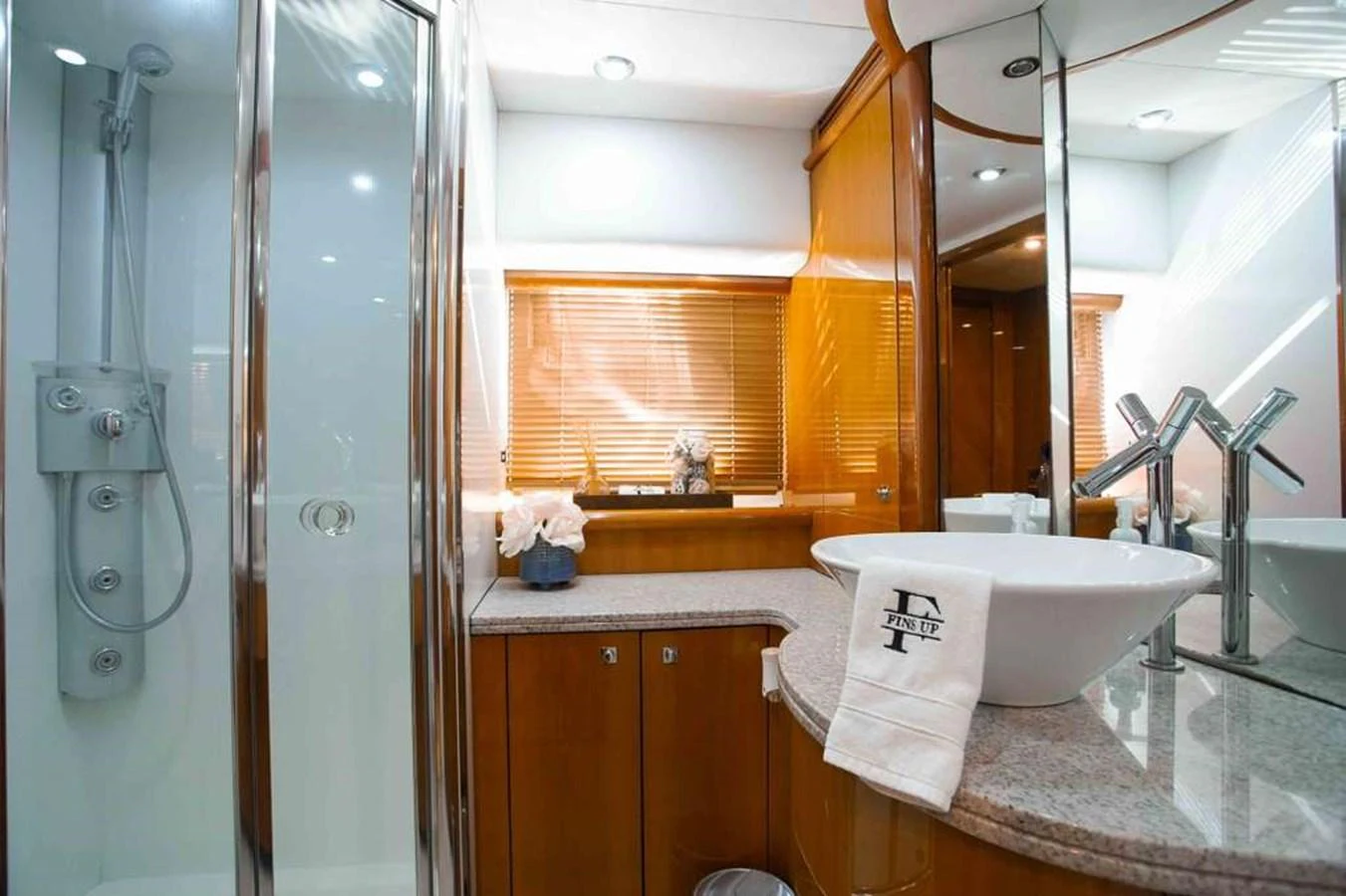 The yacht's bathroom features a modern design with a sleek shower and elegant fixtures. aboard 2006 SUNSEEKER MANHATTAN 'FINS UP' Yacht for Sale