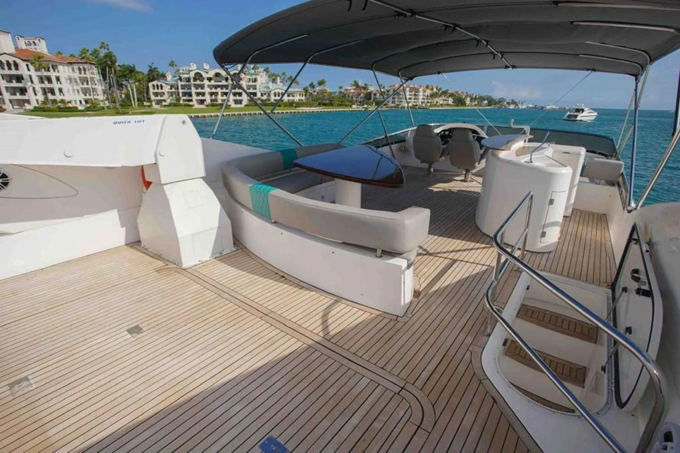 The aft deck features spacious seating and a dining area under a protective canopy, perfect for enjoying the view. aboard 2006 SUNSEEKER MANHATTAN 'FINS UP' Yacht for Sale