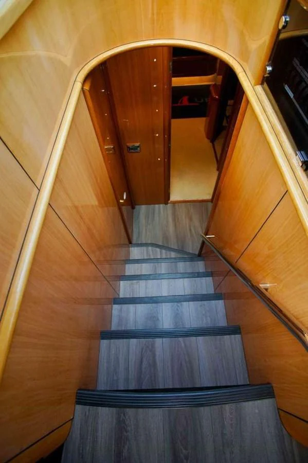A polished wooden staircase leads down to the lower deck of the yacht. aboard 2006 SUNSEEKER MANHATTAN 'FINS UP' Yacht for Sale